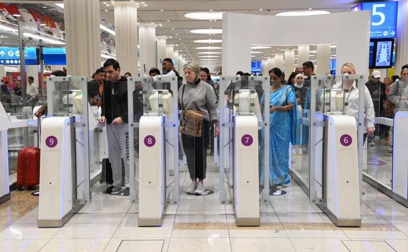 Travellers passing through passport control at Dubai International Airport