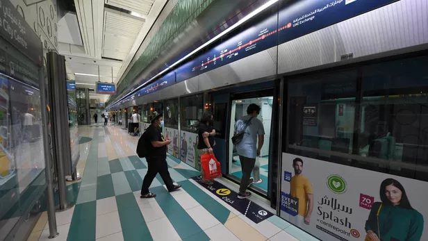 Passengers on a platform at a Dubai Metro station