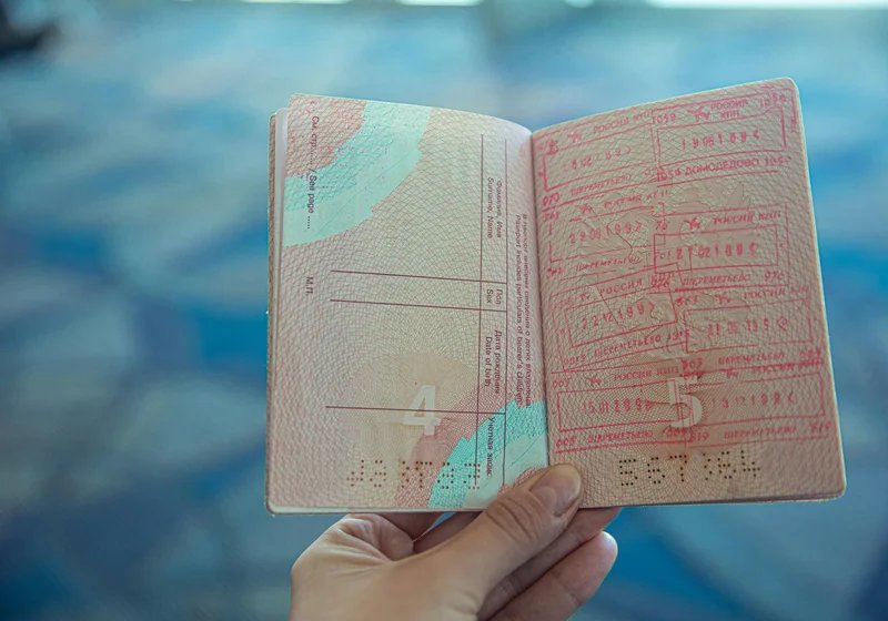 A passport and travel documents on a desk