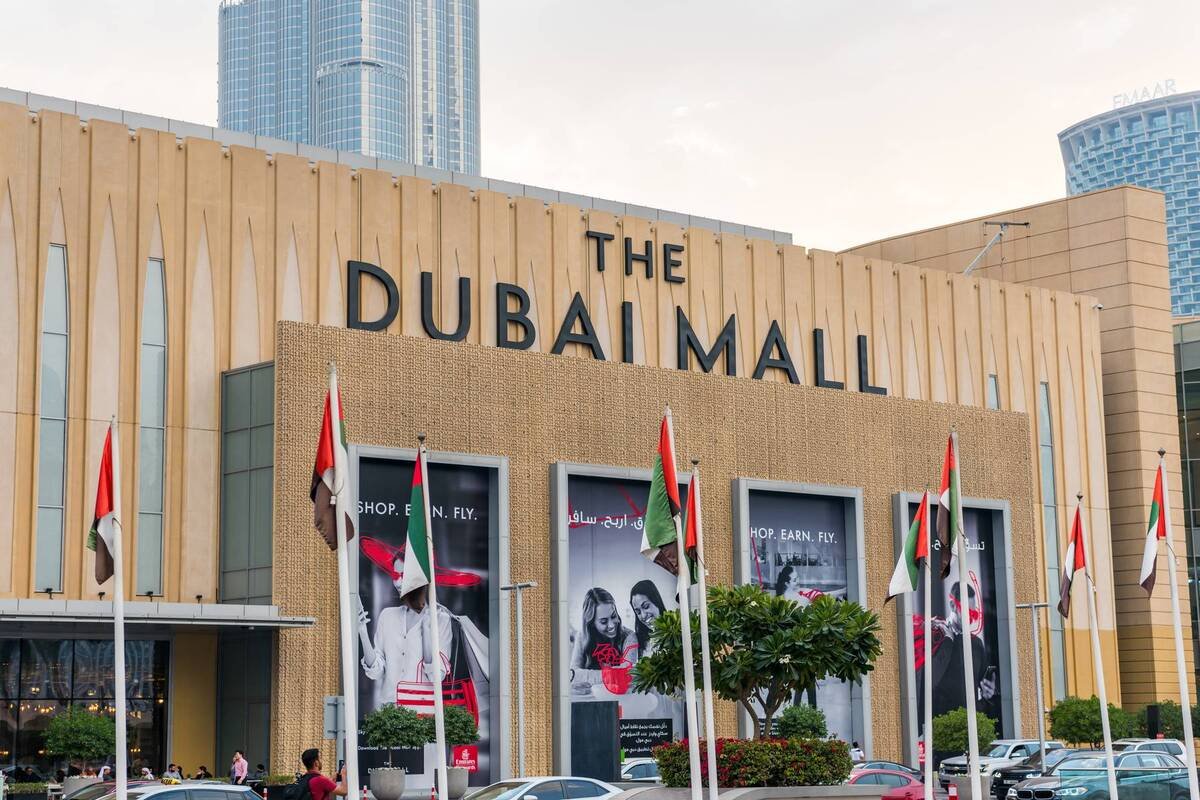 Shoppers browsing stores inside a large Dubai shopping mall