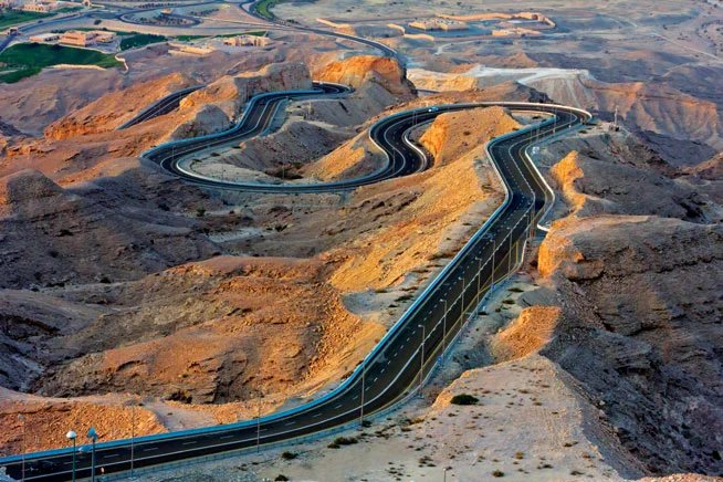 Motorway through desert towards the Hajar mountains in the northern UAE
