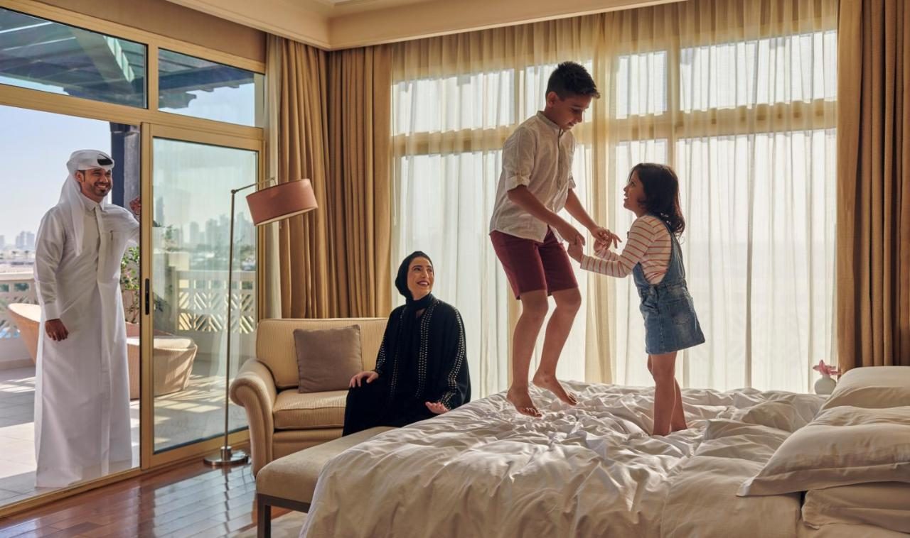 A bright family hotel room in Dubai with beds for parents and children