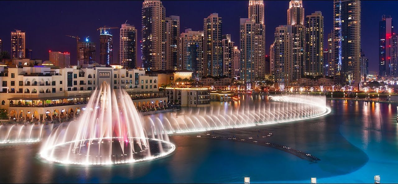 The Dubai Fountain performing in front of the Burj Khalifa at dusk