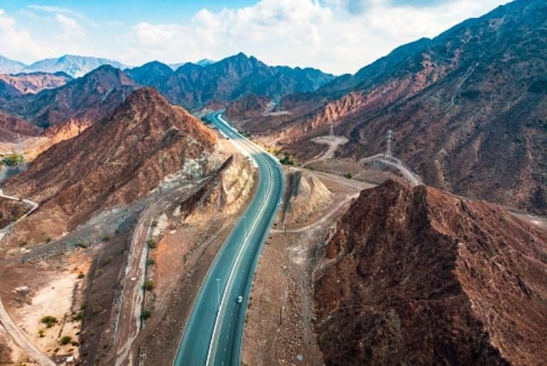 A highway cutting through the Hajar mountains towards Fujairah