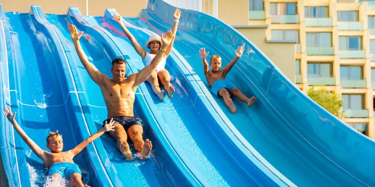 Families enjoying large water slides at a water park