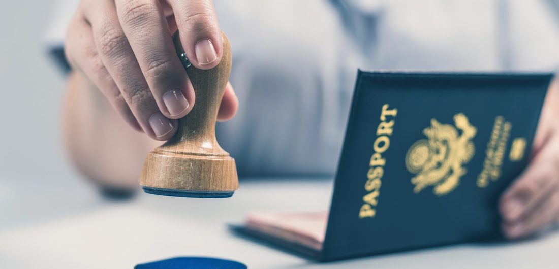 Immigration officer stamping a passport
