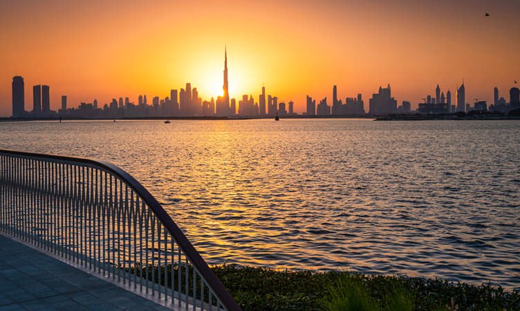 Dubai skyline seen across the water from Dubai Creek Harbour at dusk