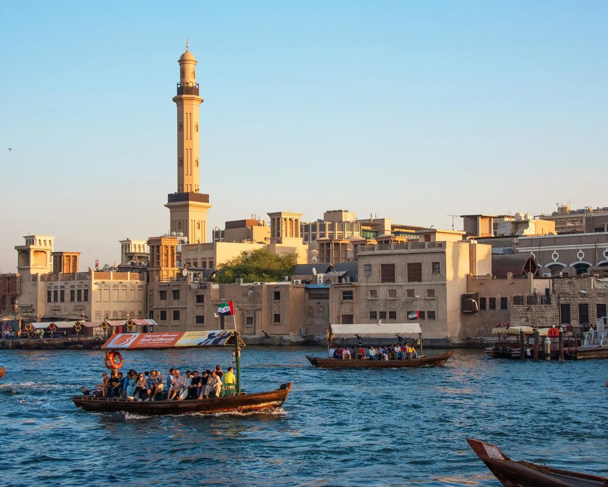A traditional abra boat carrying passengers across Dubai Creek near the souks