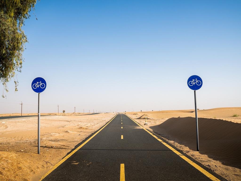 Cyclists on the Al Qudra cycle track through the desert