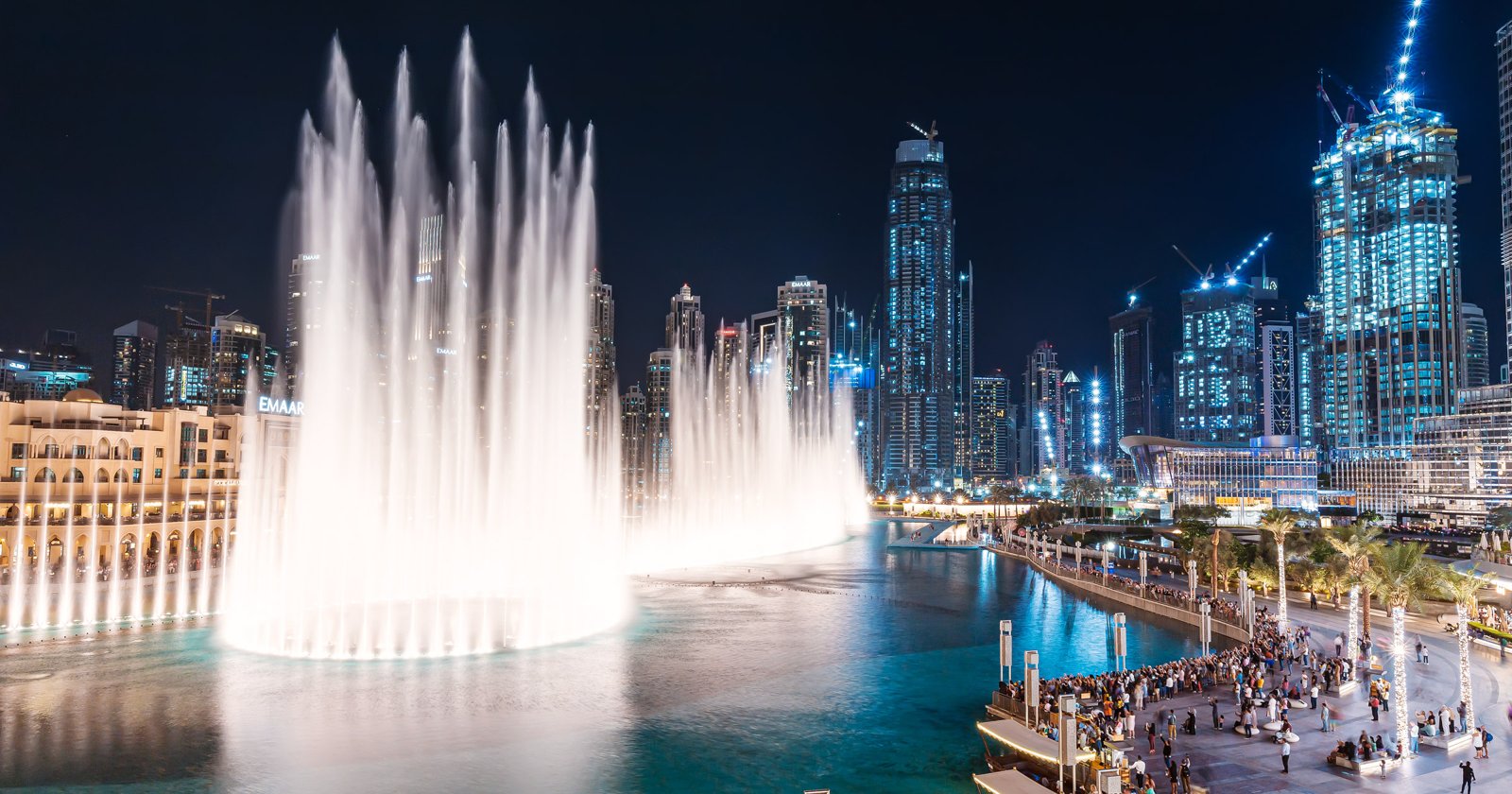 The Dubai Fountain show at night with the Burj Khalifa behind