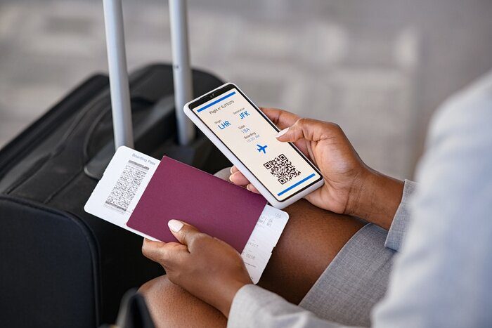 Traveller showing booking confirmations on a phone