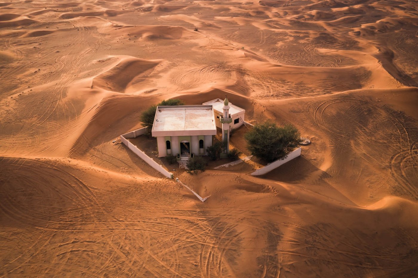 Abandoned building at Al Madam with sand piling through its rooms