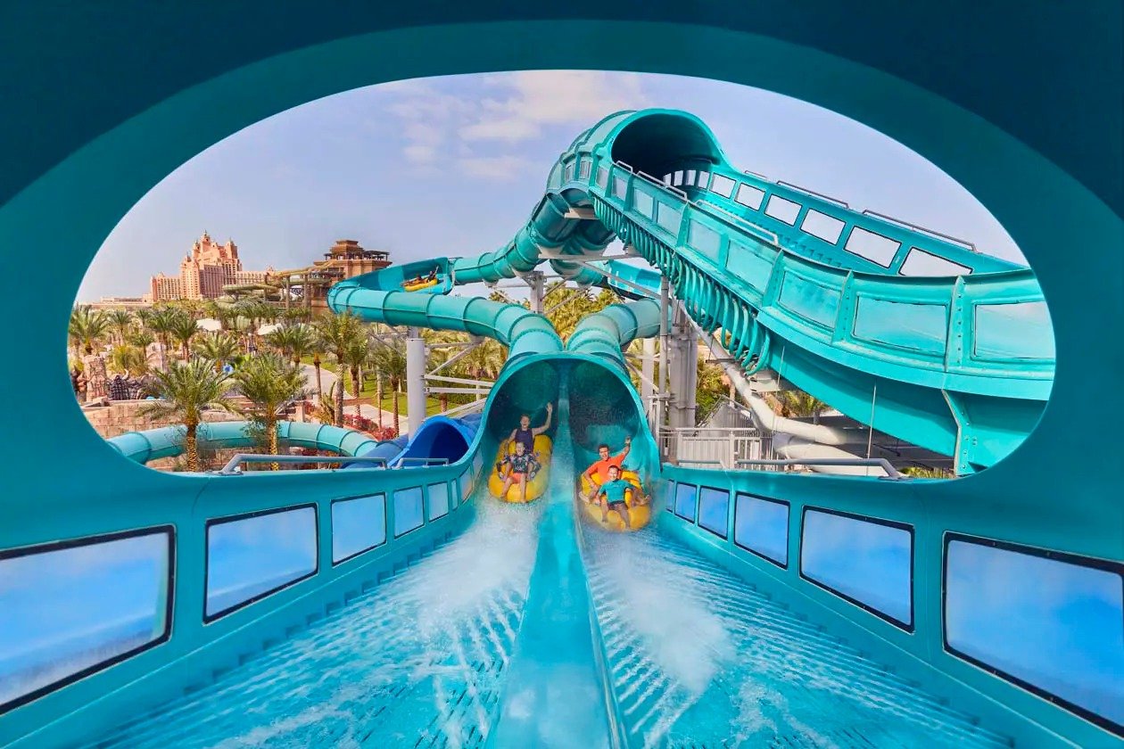 Riders on a raft slide at a large outdoor waterpark in Dubai