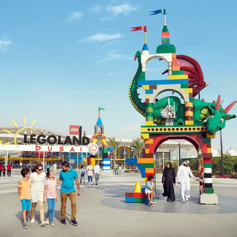 Family walking between two theme park entrances on one site