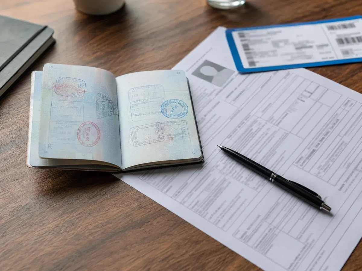 Travel documents passport photograph and application form on a desk
