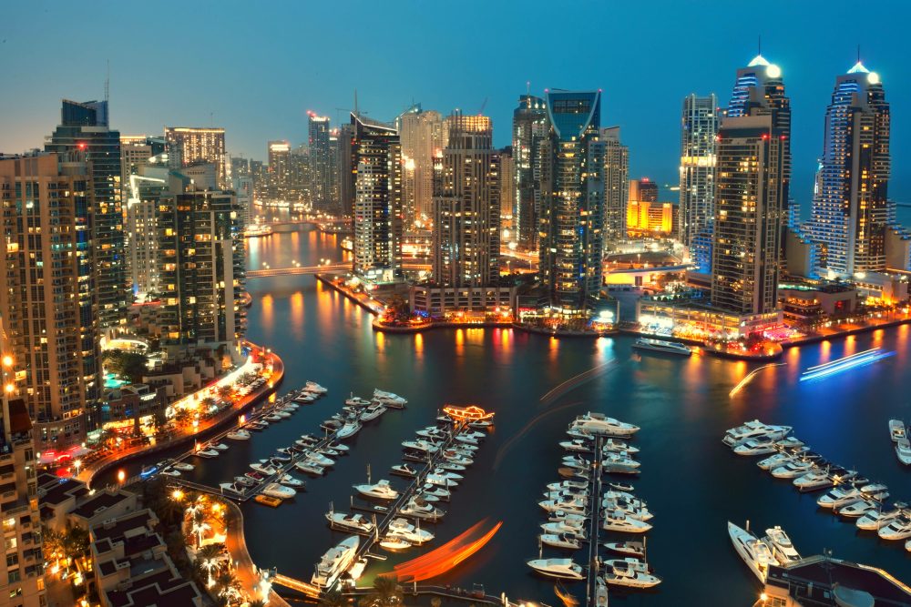 Dubai Marina at night with yachts moored along the water
