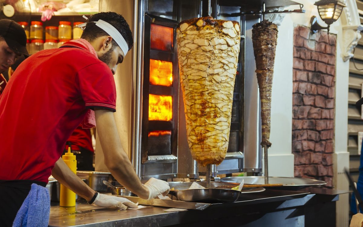 A shawarma being prepared at a small Dubai cafeteria