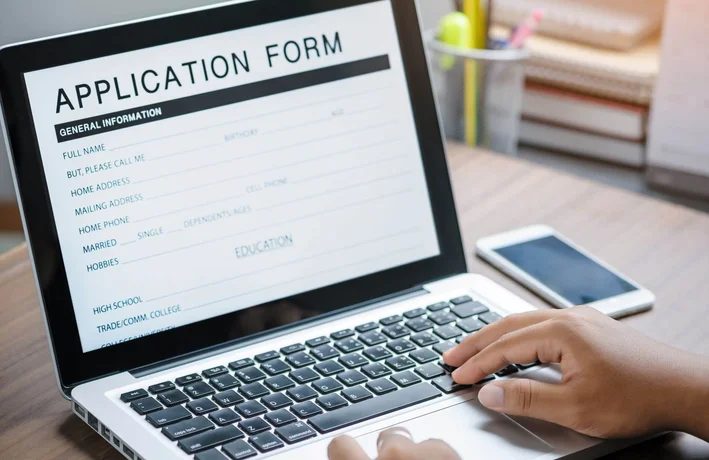 Applicant completing a government visa application online on a laptop