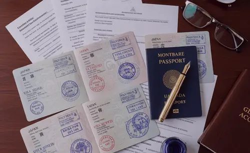 Passport photograph and paperwork arranged on a desk for a visa application
