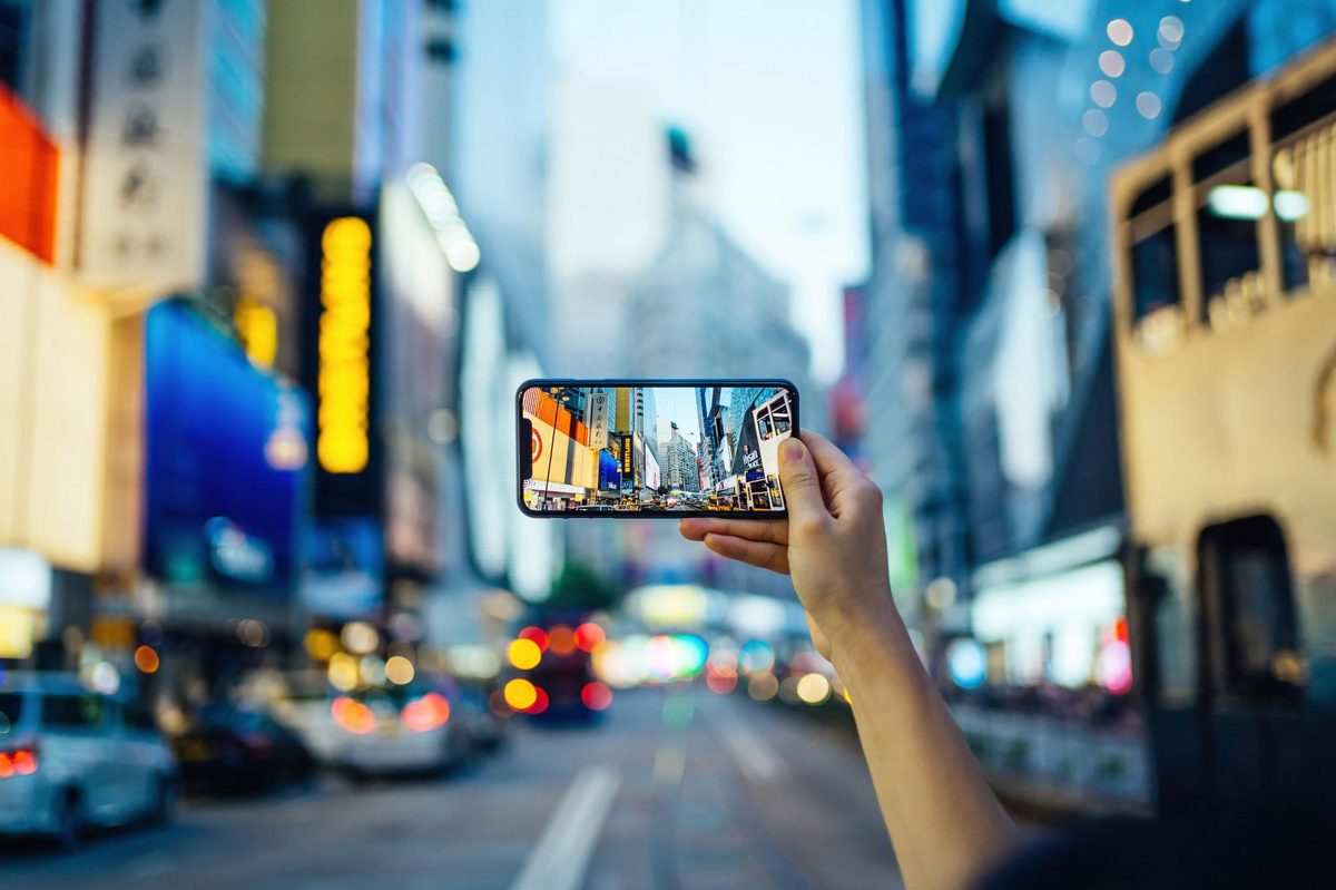 A tourist using a smartphone to plan sightseeing in a city