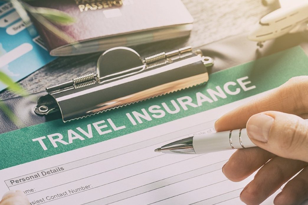 Travel documents and insurance paperwork being prepared