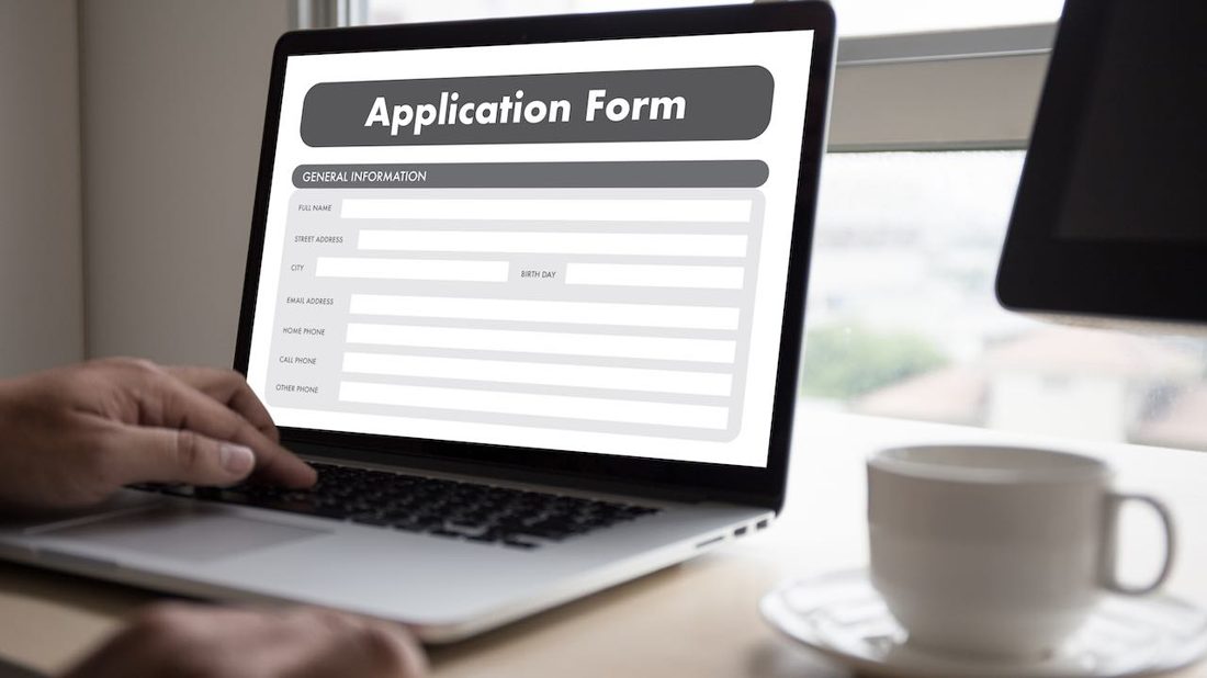 Person applying for a visa online on a laptop