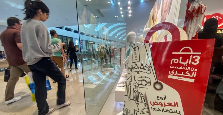 Sale signs and shoppers during a Dubai shopping festival