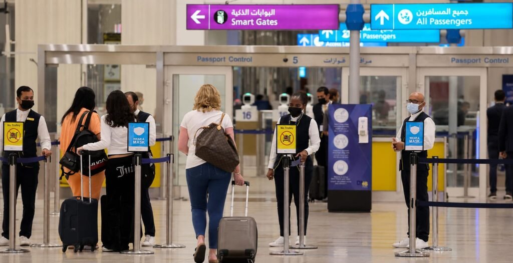 Passengers arriving at Dubai International Airport with luggage