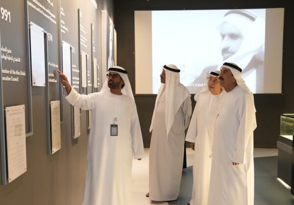 Visitors inside a modern museum exhibition about UAE history