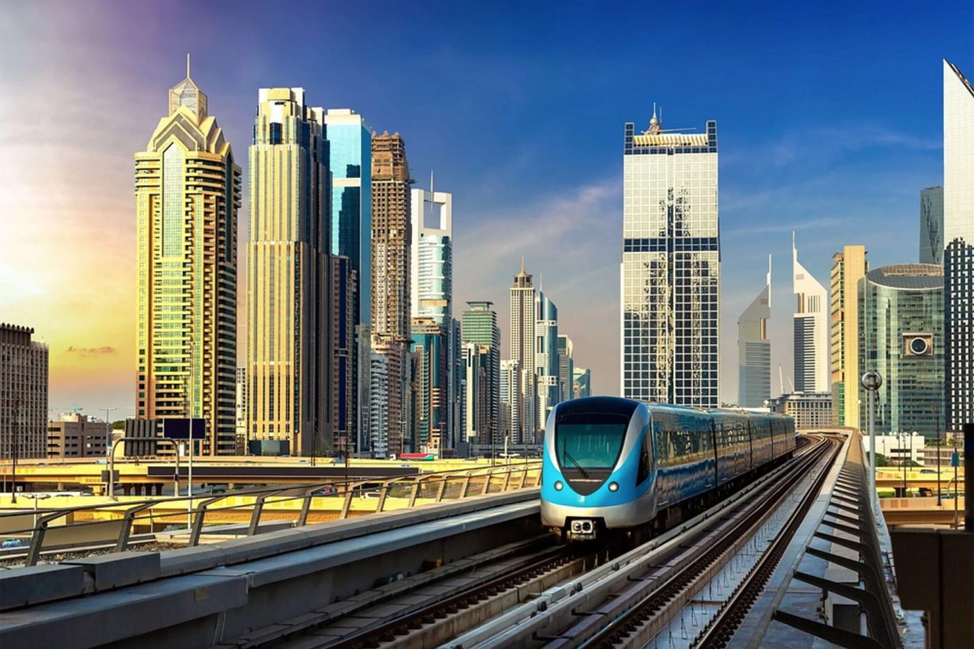 A driverless Dubai Metro train arriving at an elevated station