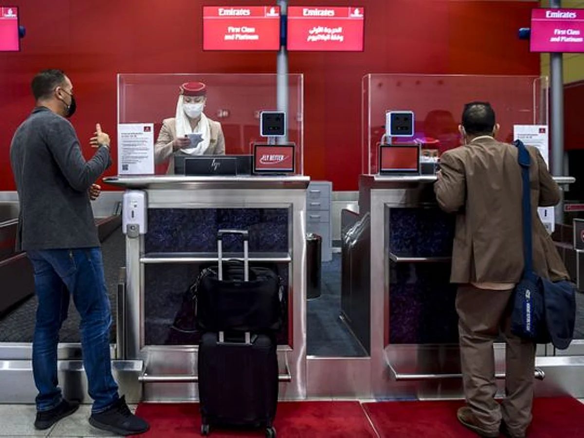 Passengers checking in at an airline counter before departure