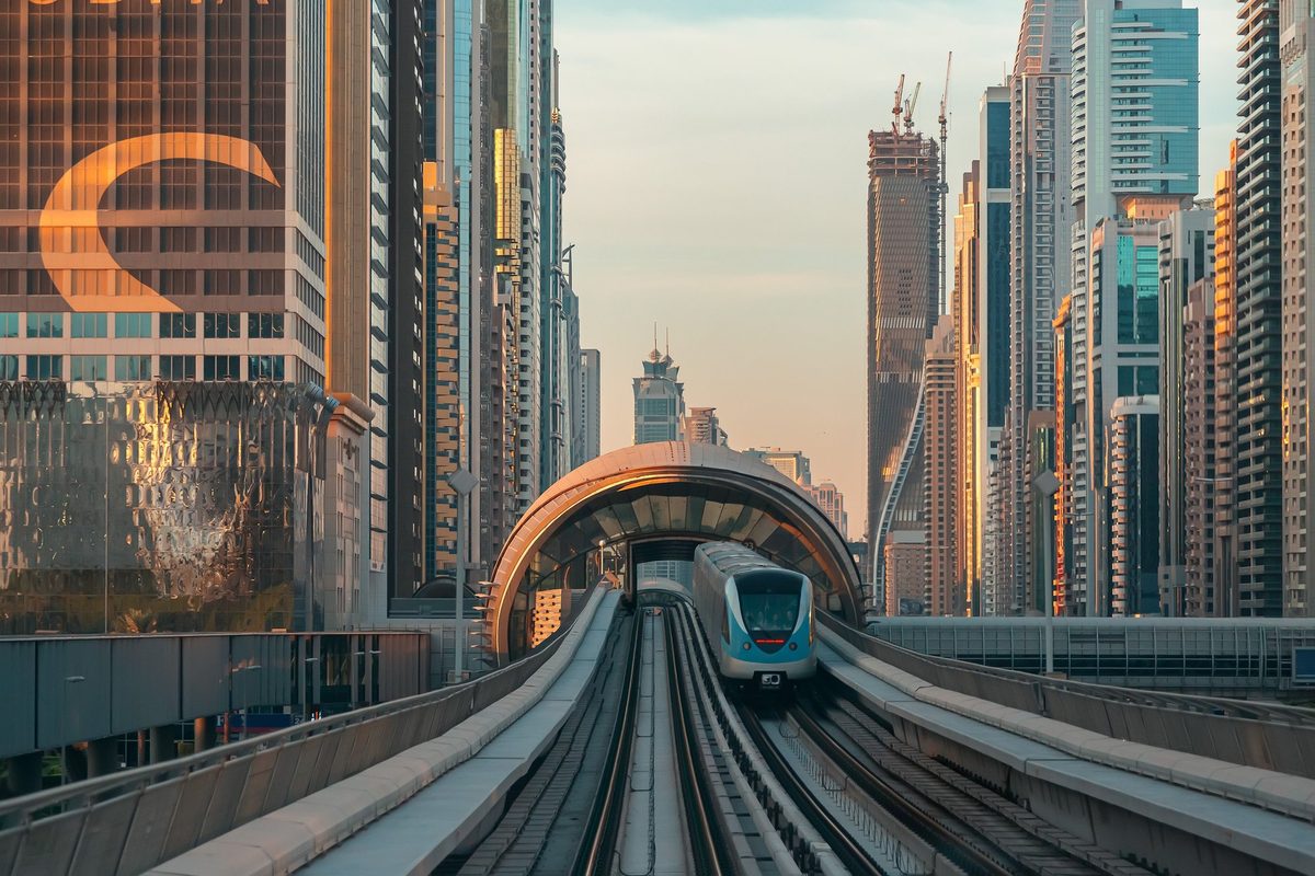 A Dubai Metro train arriving at an elevated station
