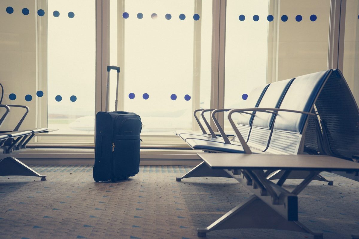 Frequent traveller waiting in an airport departure lounge with luggage