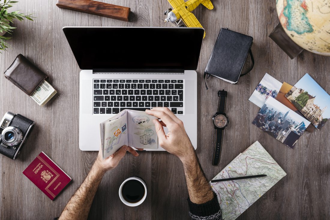 Nepalese traveller planning a Dubai trip with a laptop