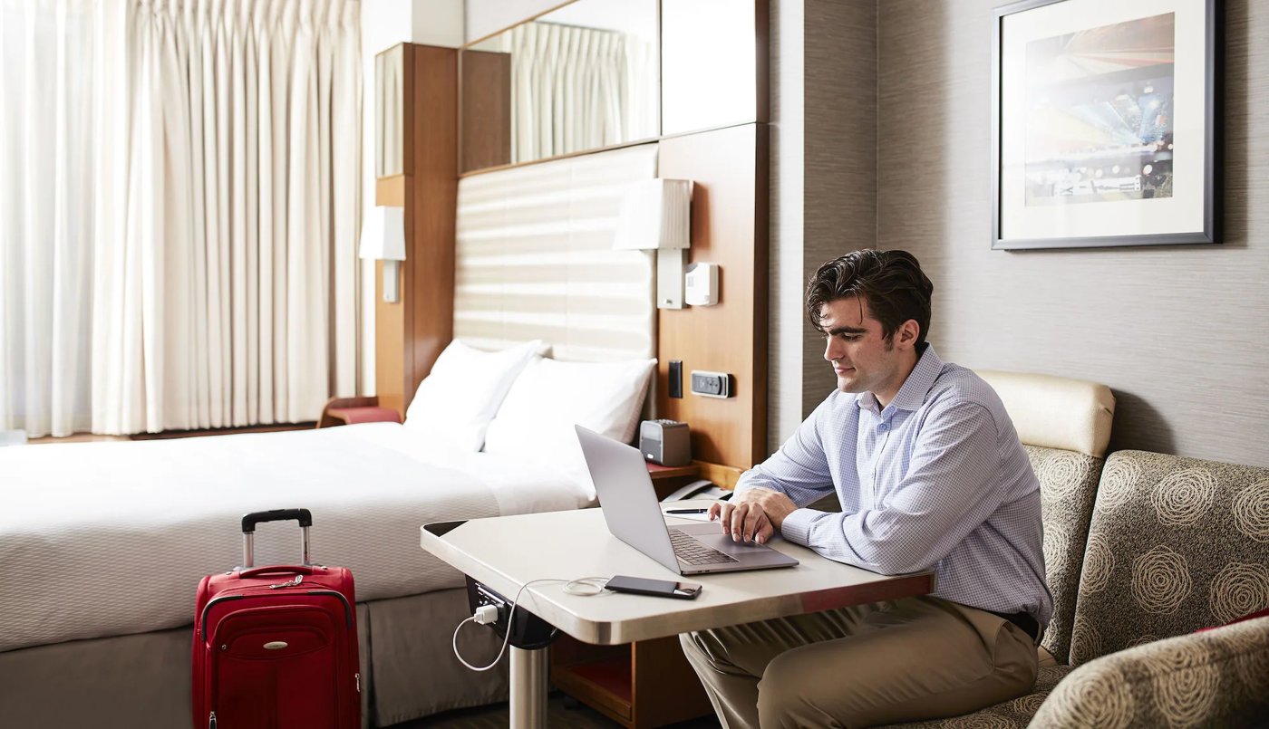 Business traveller working on a laptop in a Dubai hotel room