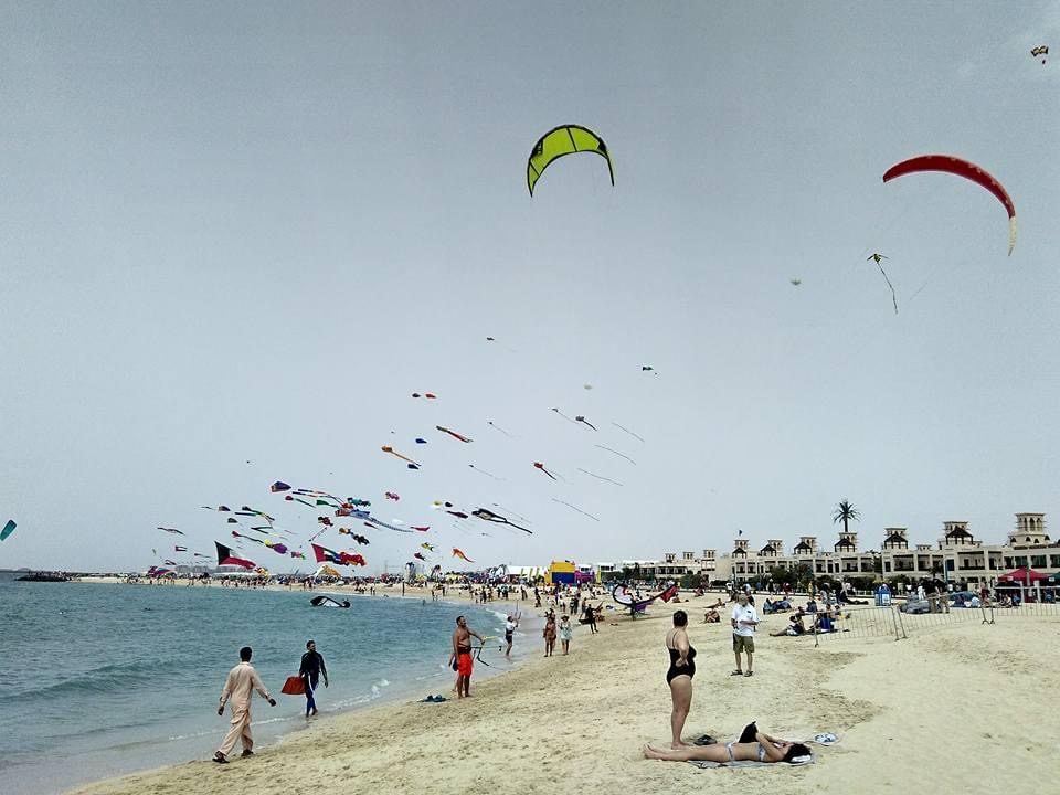 Kitesurfers and beachgoers enjoying a free public beach in Dubai